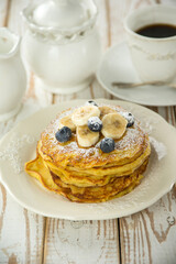 pancake with sliced bananas and bkueberry