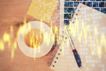 Double exposure of financial chart drawing over table background with computer. Concept of research...