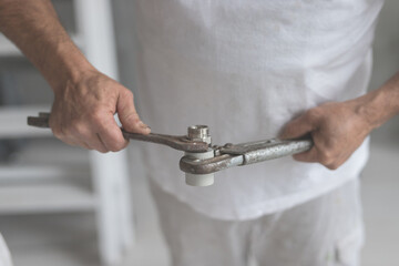 Man take two keys wrench and balloon in hands