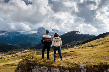 Fototapeta na wymiar Back view of couple enjoying beautiful landscape of mountain