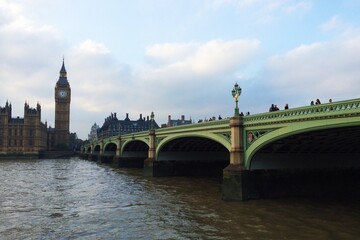 Obraz na płótnie Canvas Westminster Bridge Over Thames River Against Cloudy Sky