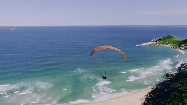 The paraglider flies over the Brazilian coast. 4K