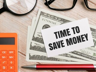 Top view pen,eye glasses,calculator,fake money and magnifying glass with text TIME TO SAVE MONEY written on white paper note.Business and financial concept.