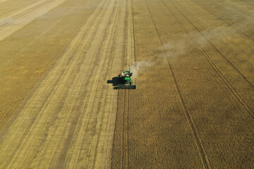 Beautiful aerial view of modern combine harvester working in field on sunny day. Agriculture...