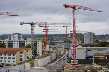 Fototapeta na wymiar Construction site with many cranes. Photo taken at Zurich Schwamendingen, Switzerland, September 26, 2020.