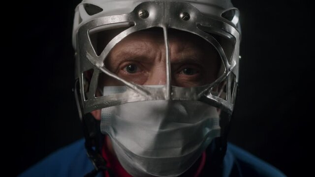 Portrait of former professional hockey player. Closeup face of hockey coach in medical mask.