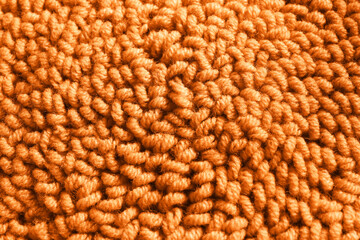 Orange woolen threads as background, top view
