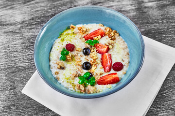 Oatmeal with strawberries and blueberries for breakfast. Healthy food and diet. Delicious and healthy food for weight loss