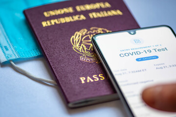 Vaccine passport app displayed an a smartphone with passport and mask 