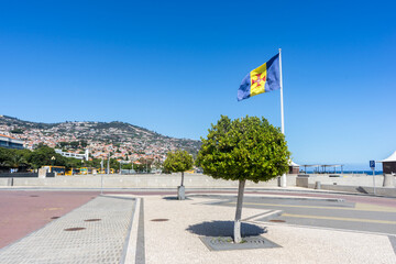 Madeira Flag with towns on mountain cliffs in the background