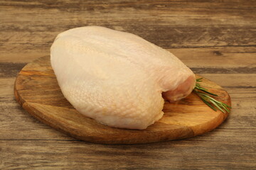 Raw whole chicken breast with skin