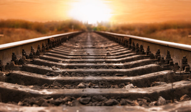 Railway line in countryside at sunset. Train journey