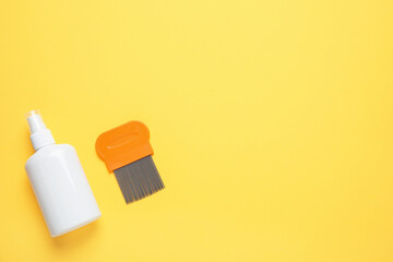 Spray and metal comb for anti lice treatment on yellow background, flat lay. Space for text