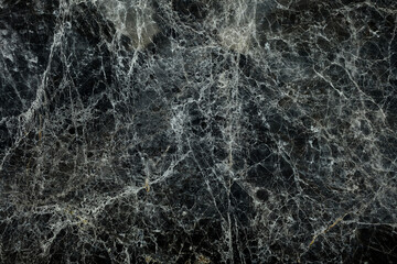 Fototapeta na wymiar Black Cracked Marble Wall with Grain, Suitable for Overlay Image.