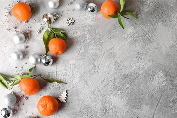 Tangerines and Christmas toys on a light background