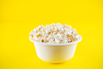 Salt popcorn on a yellow background