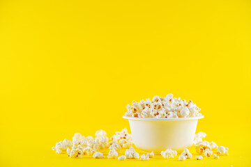 Fototapeta na wymiar Salt popcorn on a yellow background