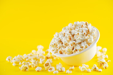 Salt popcorn on a yellow background.