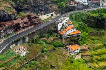 Orange roofed house at mountain Cliff, Madeira Island