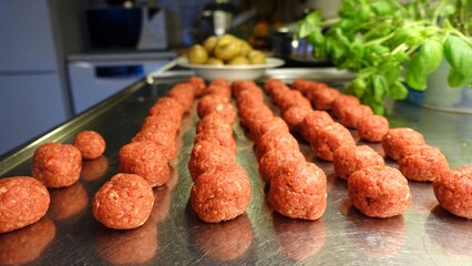 Homemade meatballs on the kitchen counter ready to be cooked