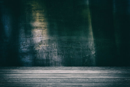 Wooden Table with Spotlight at the Center and Old Grunge Concrete Wall in Dark Tone with Grain, Suitable for Halloween Concept.