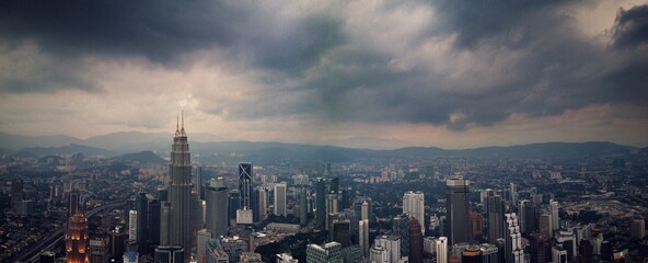 View Of Cityscape Against Cloudy Sky