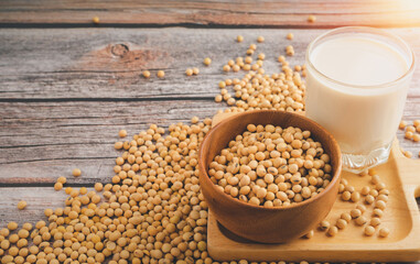 Soybeans in brown wooden bowl with Soy milk on wooden table background.Healthy food Concept.