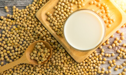Soy milk and Soybeans in wooden spoon on wooden table background.Healthy food Concept.