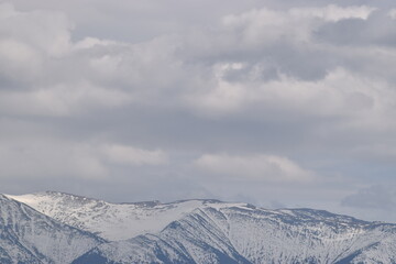 Snowy mountains and cloudy skies