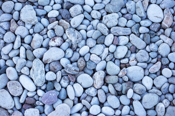 Grey pebbles on the beach background