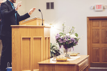 View of a pastor preaching on the pulpit in the church - obrazy, fototapety, plakaty