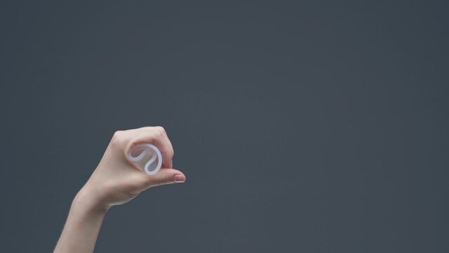 Female hand demonstrate insert of reusable menstrual cup. Zero waste menstruation hygiene. Eco alternative for periods