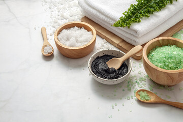Bath salt and body scrub on marble background. 