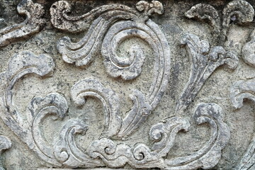 Vintage Thai Sculpture on Stone Wall.