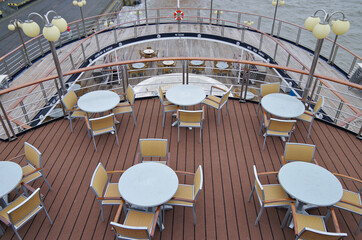 Outdoor sun and pool deck with dated rattan design patio terrace furniture, sun loungers and deck...