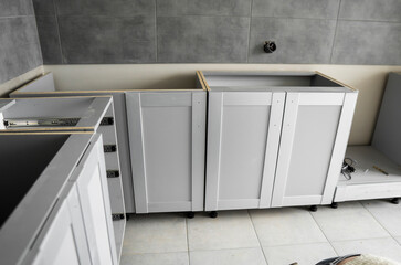 Lower custom kitchen cabinets installation with a furniture facades mdf. Gray modular kitchen from...