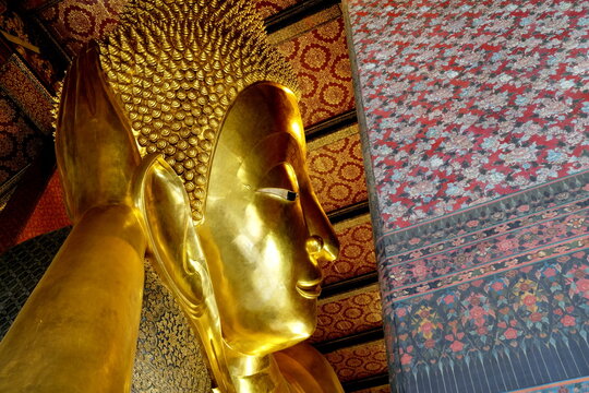 BANGKOK, THAILAND - SEPTEMBER 12, 2020: Ancient Reclining Buddha image inside Wat Pho. Wat Pho is famous temple and historical landmark of Thailand.