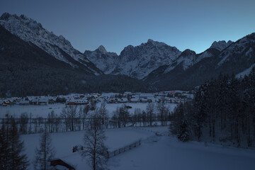 Winter and snow in Kranjska Gora village, Slovenia. Dusk or night panorama.