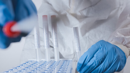 Covid-19 test. Nurses put a nasal swab into a tube. POV view shot.