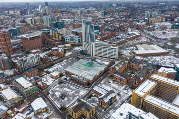 Fototapeta premium Aerial photo of the town centre of Leeds in West Yorkshire, near the Bridgewater Place apartment building along side the Leeds Train Station in the snow and winter time