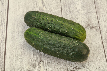 Green fresh cucumbers over background