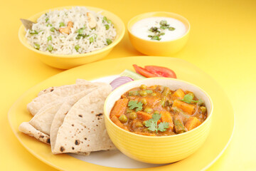 mix veg curry made from carrot, beans, and green peas served with roti, green peas pulao and curd