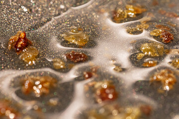 Macro shot of greaves of fries in oil in a pan.