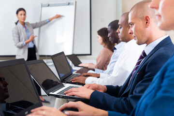 Female speaker giving talk on corporate business meeting in meeting room