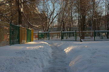 a path cleared of snow in a residential area