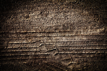 Tyre track on dirt sand or mud, Picture in retro or grunge tone. Car drive on sand. off road track. Track on grass field. Track in farm.