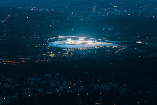 Night time cityscape view of Stuttgart, Illuminated Mercedes Benz Arena, German Bundesliga