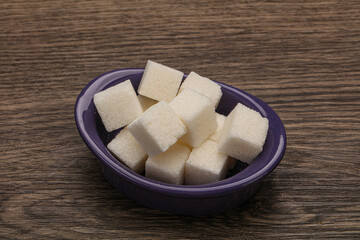 Refined white sugar cubs in the bowl