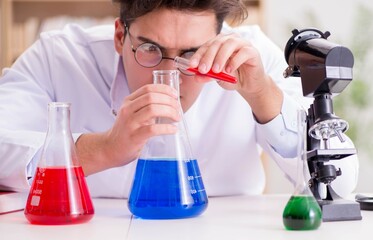 Mad crazy scientist doctor doing experiments in a laboratory