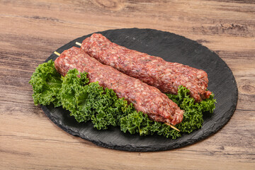 Raw minced beef kebab skewer